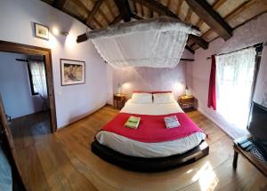 a bedroom with a large bed in a room at Agriturismo Il Cammino in San Vito al Torre