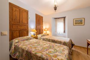 Postel nebo postele na pokoji v ubytování Casa Dieste Apartamentos Turísticos en Boltaña