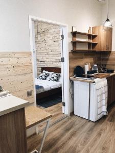 a room with a bedroom with a bed and a kitchen at Apart27 in Lviv