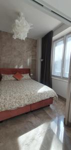 a bedroom with a bed and a large window at Pink Maison Milano Centro Piazza Diaz Duomo in Milan