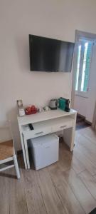 a white desk with a flat screen tv on a wall at B&B D'AMARE in Cupra Marittima +38 photos