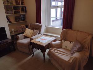 a living room with two chairs and a coffee table at Remarkable 3-Bed House in Millom in Millom