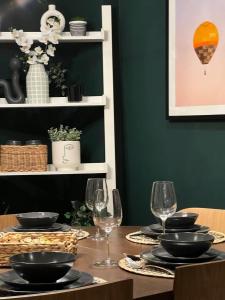 a dining room table with glasses and plates on it at Cosy and modern apartment in the heart of Dublin in Dublin
