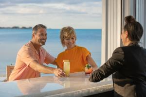 a man and woman sitting at a table with a woman at Goldwynn Resort & Residences in Nassau