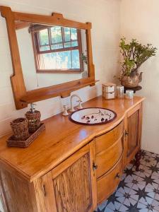 a bathroom with a wooden counter with a sink at Paradise Lodge - Blue Mountains Wonderland in Linden