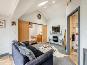 sala de estar con sofá y chimenea en Mayton Lodge en Fordwich