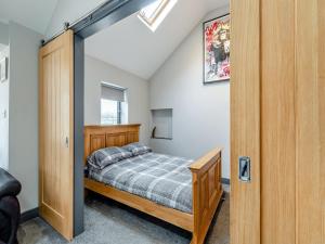a bedroom with a bed and a sliding door at Mayton Lodge in Fordwich
