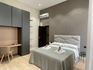 a bedroom with a bed and a table and a chair at Napoli Mariana Luxury in Naples +260 photos