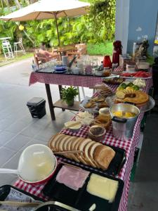 a table with a bunch of food on it at Tombo Beach Hostel & Pousada in Guarujá