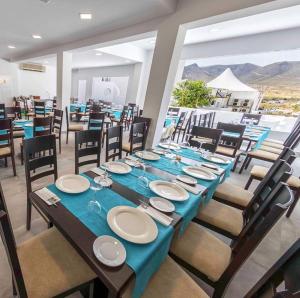 a dining room with a long table with blue table cloth at HOSTAL CASA EMILIO in Almería