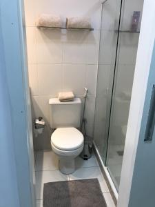 a small bathroom with a toilet and a shower at Apartamento Bora Bora Resort in Rio de Janeiro