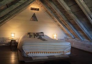 a bedroom with a large bed in an attic at Historic 1850's Cosmic Cabin 