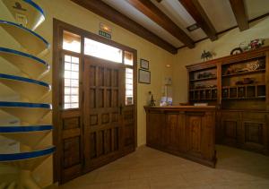 a large room with a door and a window and a counter at Hostal Rural El Tejar in Layos