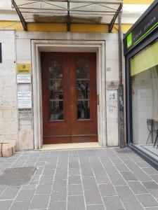 a front door of a building with a Group H H F Fosateosateosate at La Mansarda di Corso Umberto in Pescara