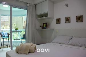 a white bedroom with a bed and a balcony at In Mare Bali Resort Beira Mar by Qavi - 57 in Parnamirim +13 photos