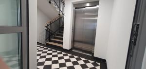 a hallway with a black and white checkered floor at Fly_to_Cracow_12 in Krakow