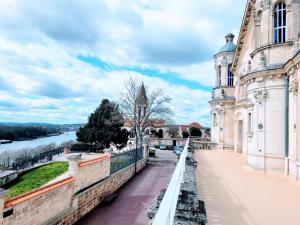 a view of a building next to a river at COSY CASE proche Paris la Défense in Conflans-Sainte-Honorine