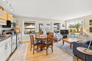 a kitchen and living room with a table and chairs at A Peaceful Suite Stay in Brentwood Bay