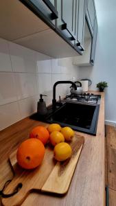 a pile of oranges on a cutting board on a kitchen counter at Pokoje Gościnne Słotwińscy in Wetlina