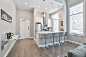a kitchen with a counter and some chairs in it at **NEW mOdernLUX best OTR condo *Park ONsite** in Cincinnati