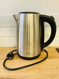 a black and silver mug on a wooden table at Les Deux Anges in Rouen +13 photos