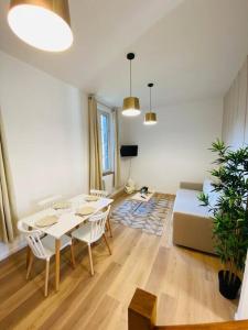 a living room with a table and a couch at Les Deux Anges in Rouen