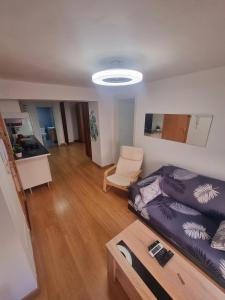 a living room with a bed and a table in it at Playa 130m in Málaga