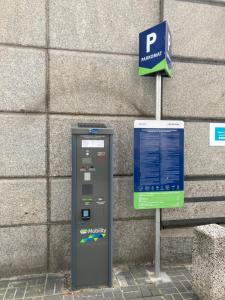 a parking meter sitting next to a building at Cozy Apartment in Centrum Downtown Śródmieście Żelazna Zelazna Jerozolimskie Palace of Culture and Science! Wifi, Netflix, HBO, SmartTV 55cal in Warsaw