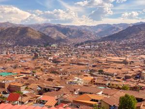 an aerial view of a city with houses and mountains at Sueños Sambleños in Cusco