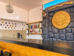 a bar in a restaurant with a stone wall at Sueños Sambleños in Cusco