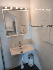 a white bathroom with a sink and a mirror at Hotel Hornsgatan in Stockholm +37 photos