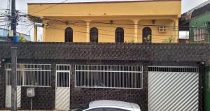 a white car parked in front of a building at Hospedagem da Almira - Apartamento 2 in Manaus