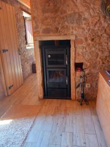 a living room with a fireplace in a stone wall at Carregã Water mill in Penela