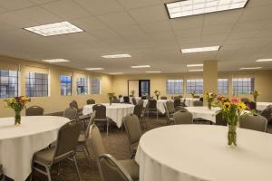a conference room with tables and chairs with flowers on them at GreenTree Inn & Suites Phoenix Sky Harbor in Phoenix +47 photos