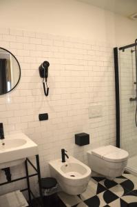 a bathroom with a sink and a toilet and a shower at RE Versiliana Junior-House in Marina di Pietrasanta