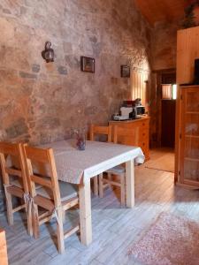 a dining room with a table and some chairs at Carregã Water mill in Penela