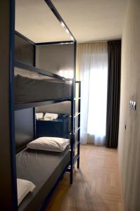 a bedroom with two bunk beds and a window at RE Versiliana Junior-House in Marina di Pietrasanta