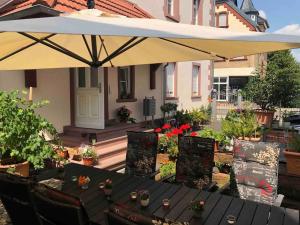 a patio with a table and an umbrella at LUXURY NEAR FRANKFURT 8 PERSON 24 7 CHECK in Hanau am Main