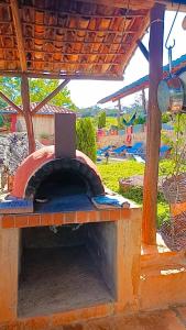 a brick oven with a laptop on top of it at Casa Upa ,casa con piscina espectacular, Barichara in Barichara