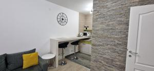 a living room with a couch and a bar in a room at Studio 7 in Novi Sad