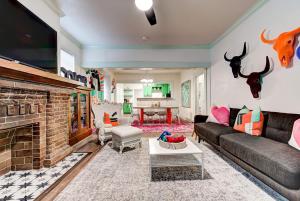 a living room with a couch and a fireplace at Color Pop Cottage - Half mile from Plaza district in Oklahoma City