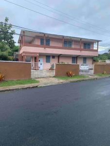 a pink house on the side of a street at 3BR spacious, dorado beach apartment, -20% monthly in Dorado