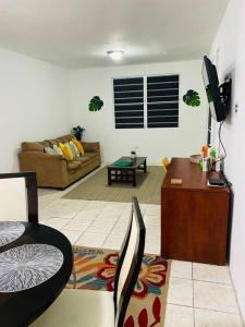 a living room with a couch and a table at 3BR spacious, dorado beach apartment, -20% monthly in Dorado