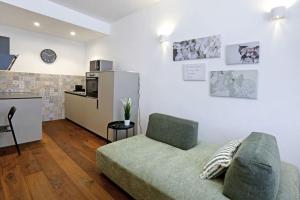 a living room with a couch and a kitchen at Wally apartment in Ljubljana