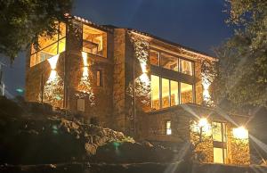 a house lit up at night with lights at Maison typique Corse écologique in Coti-Chiavari