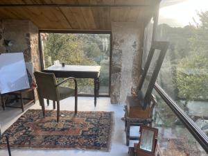a living room with a table and a chair at Maison typique Corse écologique in Coti-Chiavari +46 photos