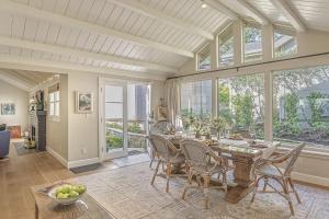a dining room with a table and chairs and windows at 3884 Twenty-One Oaks home in Carmel