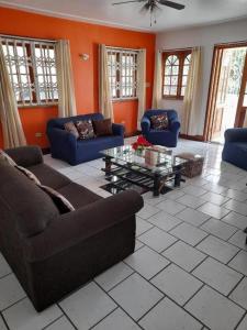 a living room with couches and a coffee table at Melrose Place in Montego Bay