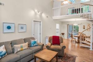 a living room with a couch and a chair at Beaufort 2 Blythewood Road in Beaufort