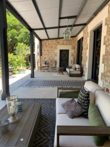 a patio with a couch and a table at Bungala House in Yankalilla